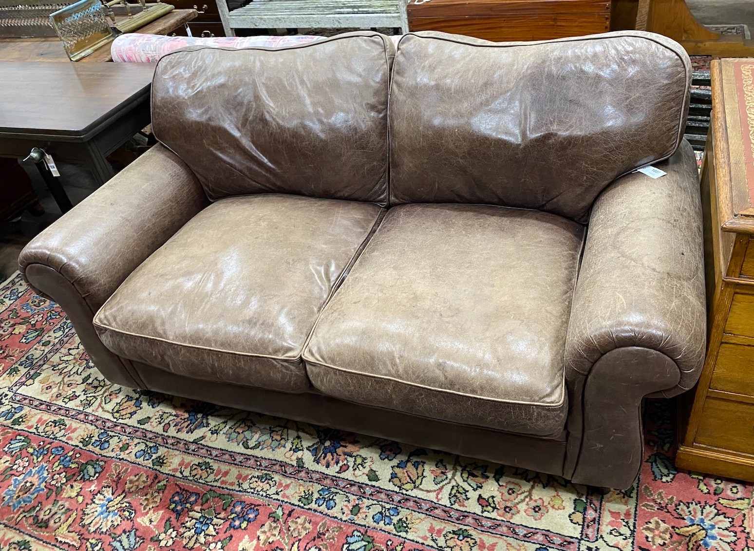A Laura Ashley brown leather upholstered two seater settee, width 172cm